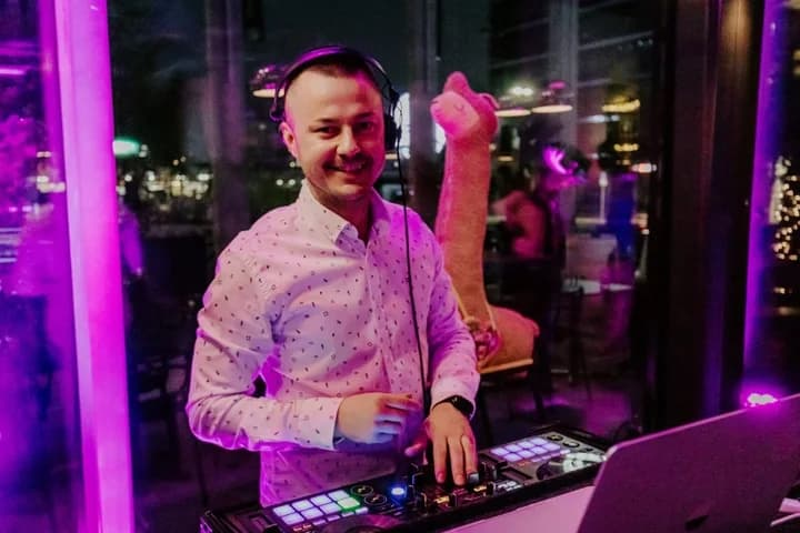 DJ Canis mit Kopfhörern an seinem DJ Pult